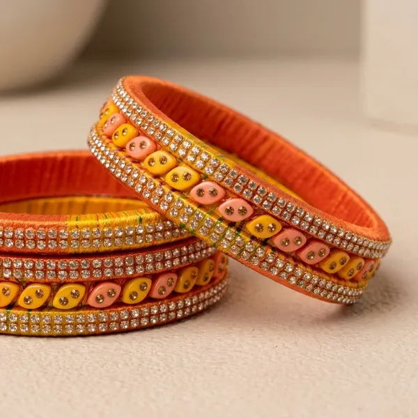 Orange_And_Yellow_Lac_Silk_Thread_Stone_Embellished_Bangle_Set_For_Women