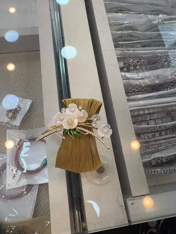 Gold_Floral_Bracelet_With_White_Stones_And_Green_Leaves