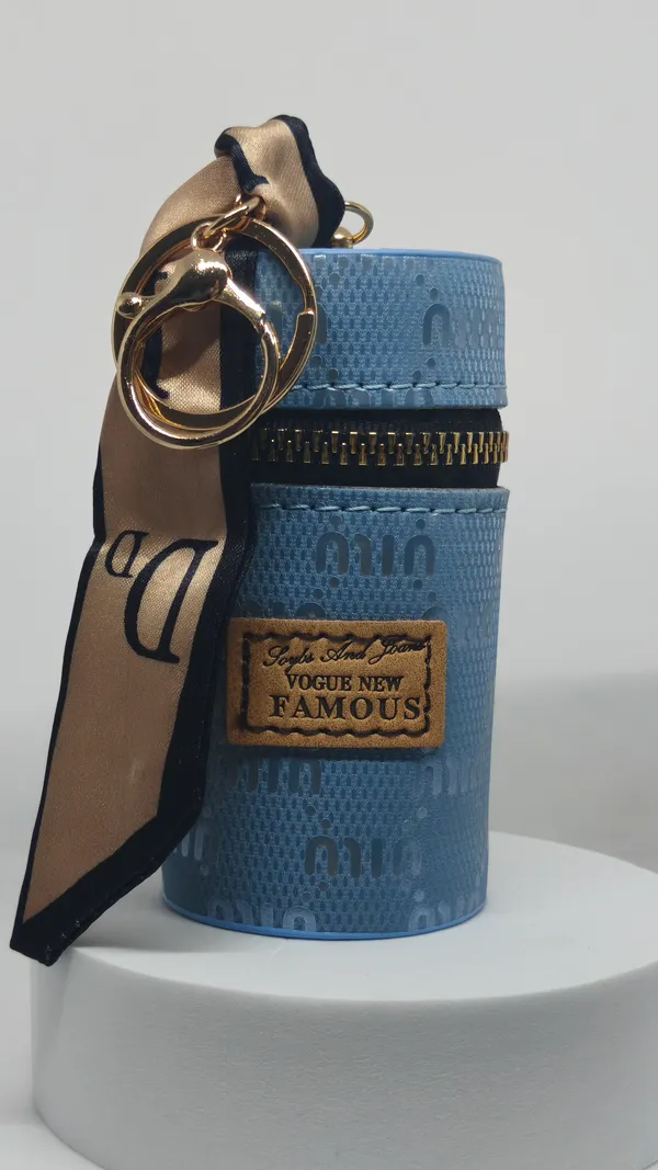 Blue_Textured_Cylindrical_Sling_Bag_With_Ribbon_Keychain