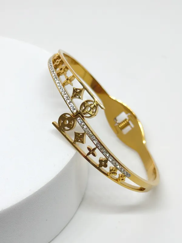 Gold-Tone_Designer_Cutwork_Bangle_with_Crystal_Embellishments