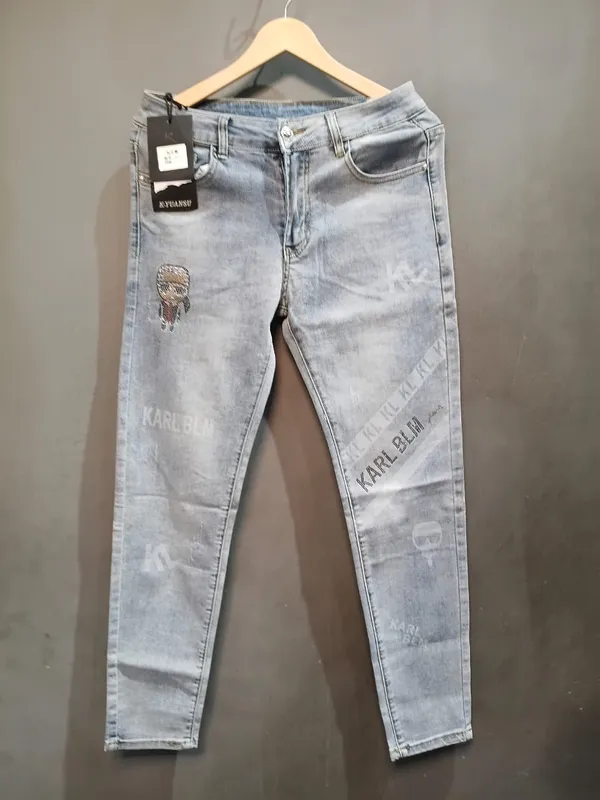 Light_Blue_Denim_Tapered_Fit_Distressed_Graphic_Jeans_For_Men