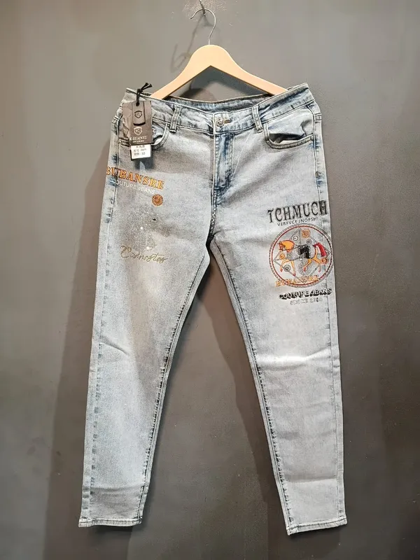 Light_Blue_Denim_Relaxed_Fit_Distressed_Embroidered_Patch_Jeans_For_Men