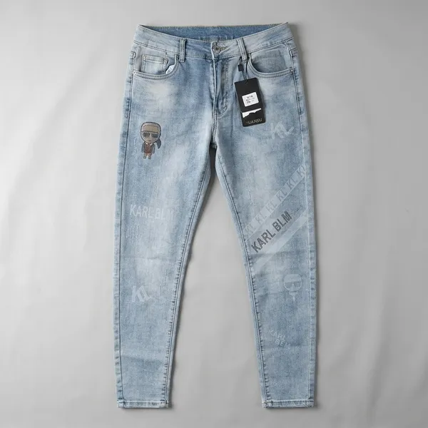 Light_Blue_Denim_Tapered_Fit_Distressed_Graphic_Jeans_For_Men