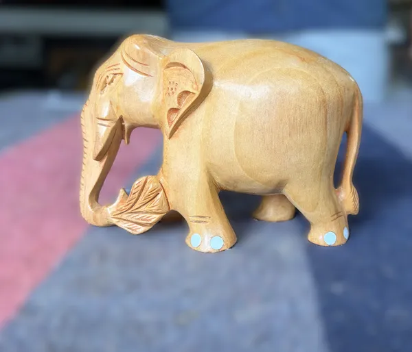 Hand-Carved_Natural_Wood_Elephant_Holding_Leaf_Branch_–_Solid_Kadam_Timber_Wildlife_Desktop_Figurine