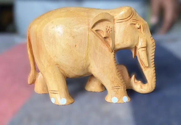 Hand-Carved_Natural_Wood_Elephant_Holding_Leaf_Branch_–_Solid_Kadam_Timber_Wildlife_Desktop_Figurine