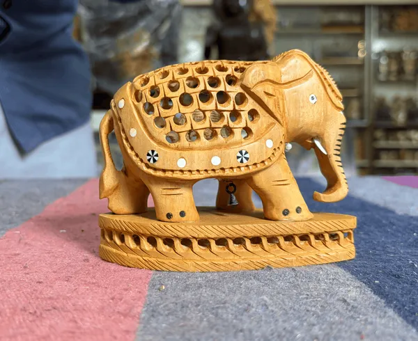 Hand-Carved_Kadam_Wood_Undercut_Elephant_with_Baby_Inside_Single-Block_Jali_Openwork_Fretwork_Showpiece_Maternal_Vastu_Decor