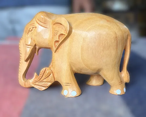 Hand-Carved_Natural_Wood_Elephant_Holding_Leaf_Branch_–_Solid_Kadam_Timber_Wildlife_Desktop_Figurine