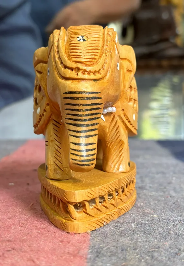 Hand-Carved_Kadam_Wood_Undercut_Elephant_with_Baby_Inside_–_Single-Block_Jali_Openwork_Fretwork_Showpiece_–_Maternal_Vastu_Decor