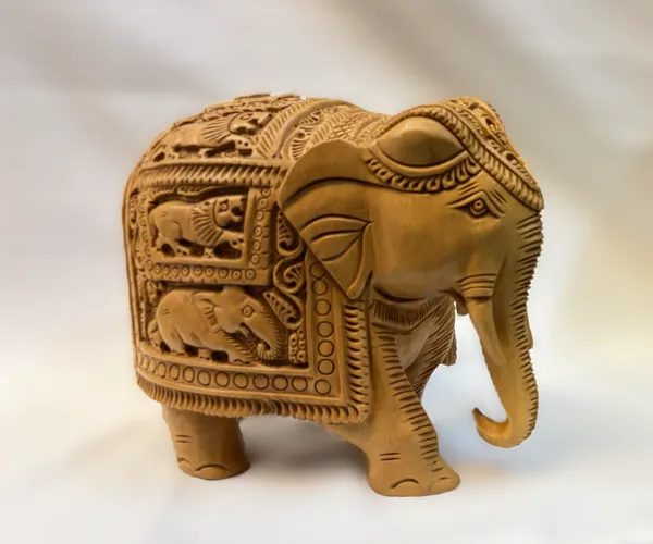 Masterpiece_Hand-Carved_Solid_Wood_Elephant_with_Detailed_Wildlife_Panels_–_Natural_Timber_Bas-Relief_Centerpiece