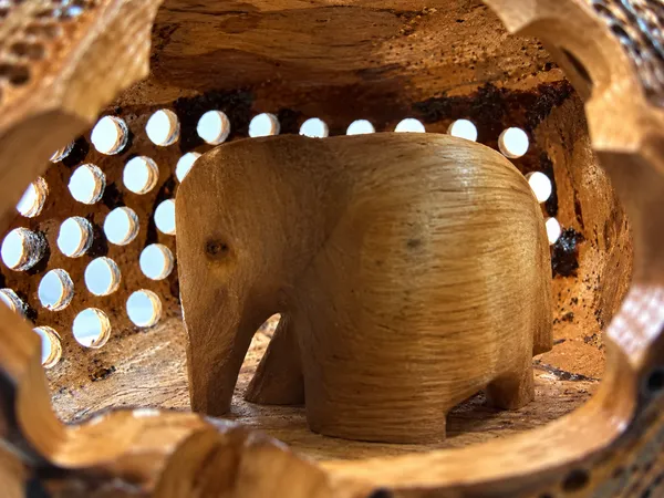 Hand-Carved_Undercut_Wooden_Elephant_with_Antique_Patina_Detailing_&_Baby_Inside_–_Single-Block_Jali_Fretwork_Sculpture