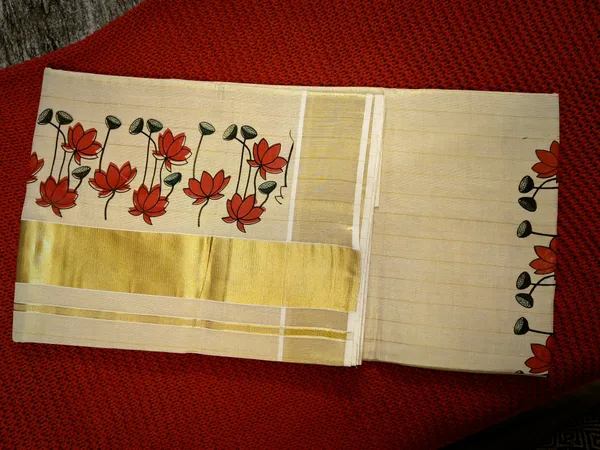 Cream_Kerala_Tissue_Cotton_Saree_With_Red_Floral_Border