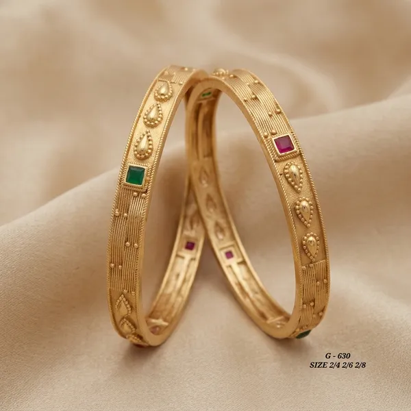 Gold_Tone_Textured_Bangles_With_Red_And_Green_Stones