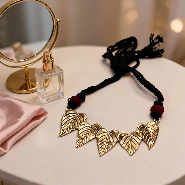 Golden_Brass_Dokra_Leaf_Pendant_Black_Thread_Necklace_For_Women