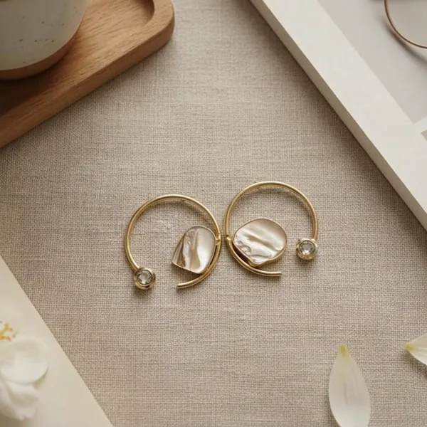 Highlighting_The_Golden_Radial_Design_And_The_Unique_Stone_In_Between_Feature_Metal_Drops_And_Danglers