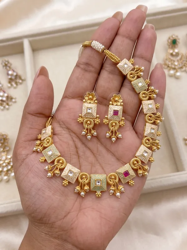 Gold_Alloy_Elephant_Motif_Pink_Stone_Necklace_Set_For_Women