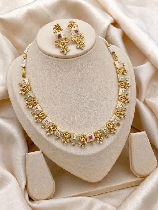Gold_Alloy_Elephant_Motif_Pink_Stone_Necklace_Set_For_Women