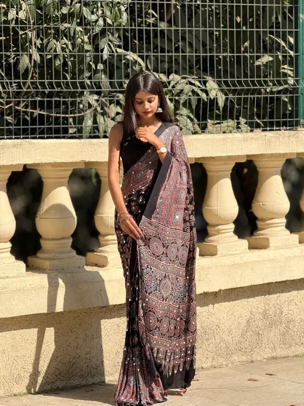 TRANDING_BLACK_AJARAKH_BUTTA_LOTUS_MODAL_SILK_MIRROR_WORK_PREMIUM_SAREE_FOR_WOMEN