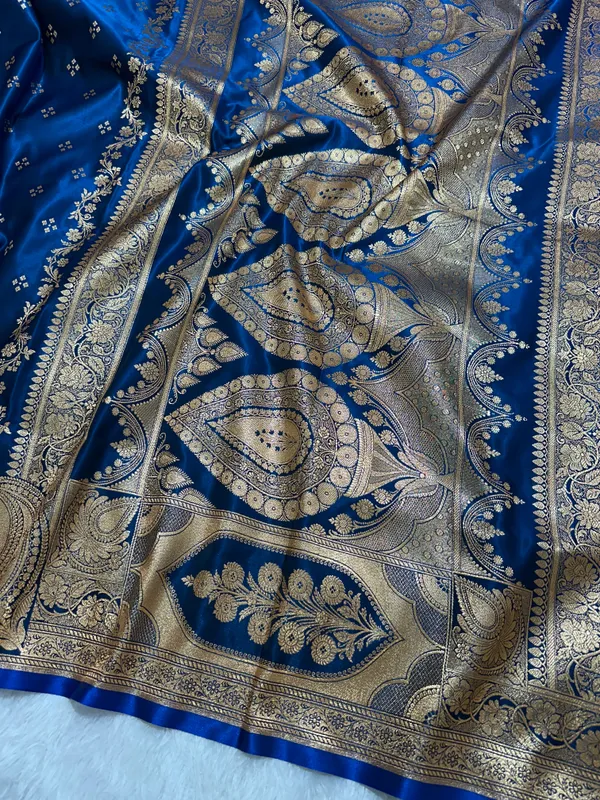 Royal_Peacock_Blue_Satin_Silk_Banarasi_Saree_With_Royal_Floral_Jhallar_Border_And_Geometric_Chowk_Butis