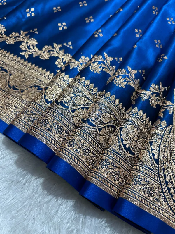 Royal_Peacock_Blue_Satin_Silk_Banarasi_Saree_With_Royal_Floral_Jhallar_Border_And_Geometric_Chowk_Butis