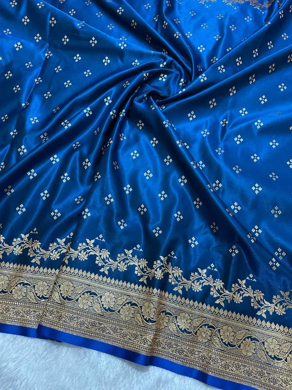 Royal_Peacock_Blue_Satin_Silk_Banarasi_Saree_With_Royal_Floral_Jhallar_Border_And_Geometric_Chowk_Butis
