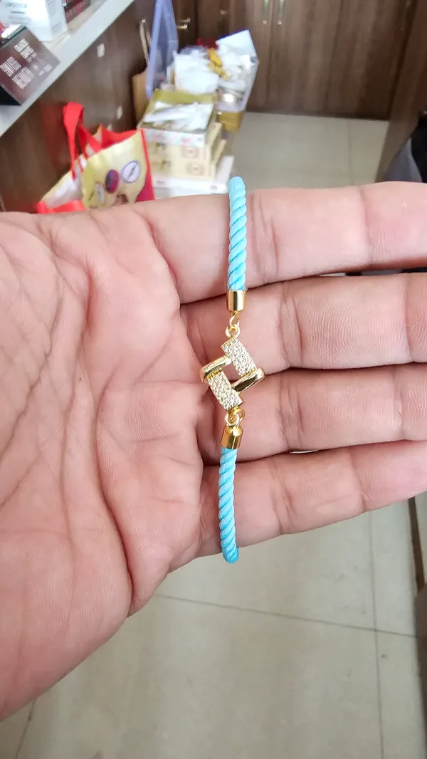 Turquoise_Cord_Gold_Charm_Adjustable_Rakhi