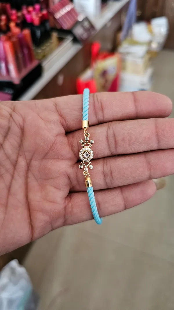 Turquoise_Thread_Gold_Toned_Rakhi_With_Crystal_Charm