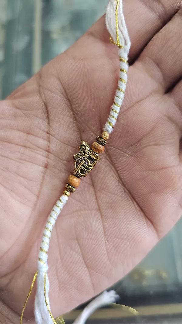 White_And_Yellow_Thread_Rakhi_With_Golden_Hamsa_Charm_Pack_Of_3