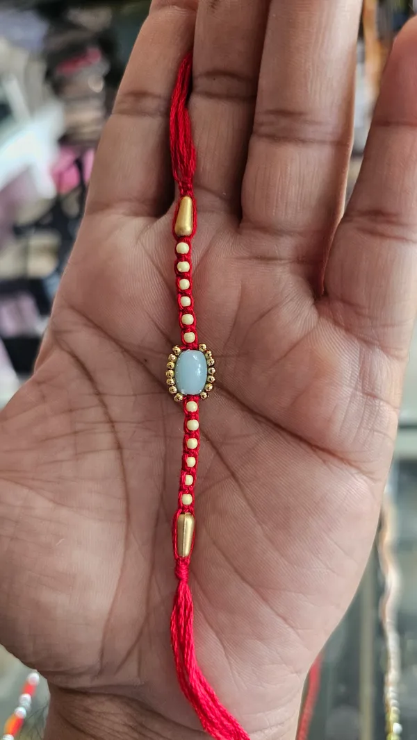 Red_Thread_Rakhi_With_Pearl_And_Stone_Embellishments_Pack_Of_4