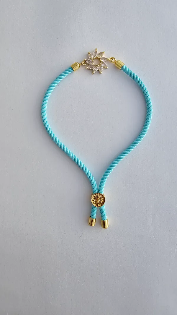 Turquoise_Cord_Gold_Flower_Charm_Rakhi