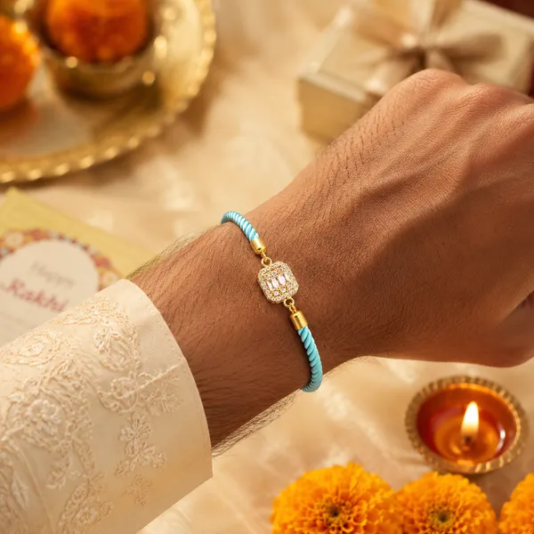 Turquoise_Cord_Gold_Toned_Studded_Charm_Rakhi