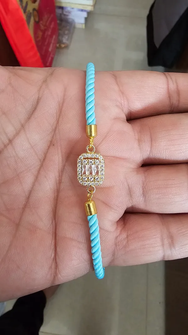 Turquoise_Cord_Gold_Toned_Studded_Charm_Rakhi