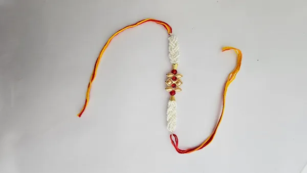 Pearl_Beaded_Golden_Floral_Rakhi_With_Red_Stones