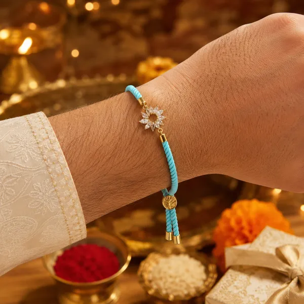 Turquoise_Cord_Gold_Flower_Charm_Rakhi