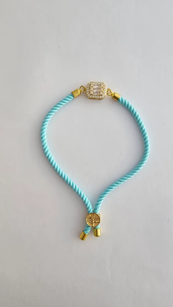 Turquoise_Cord_Gold_Toned_Studded_Charm_Rakhi