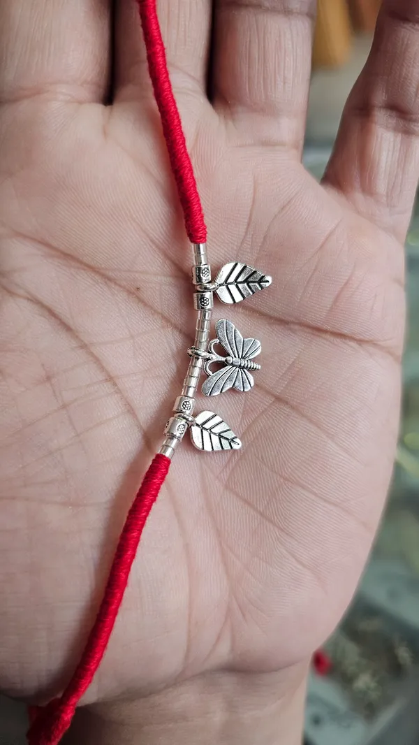 Silver_Leaf_And_Butterfly_Charm_Rakhi_With_Red_Thread_Pack_Of_3