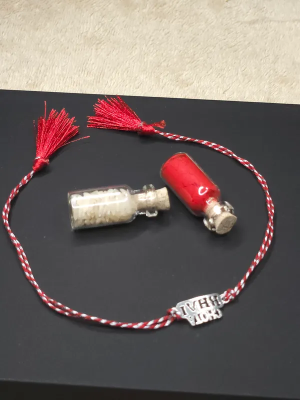 925_Silver_Rakhi_With_Roli_Chawal_Glass_Bottle_And_Happy_Rakhi_Card
