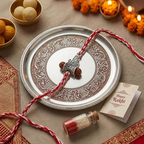 Om_Namah_Shivay_Silver_Rakhi_With_Roli_Chawal_Glass_Bottle_And_Happy_Rakhi_Card