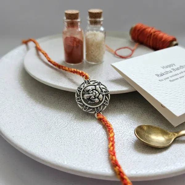 Silver_Sun_Thread_Rakhi_For_Brother_With_Kumkum_Chawal_Bottle_And_Greeting_Card