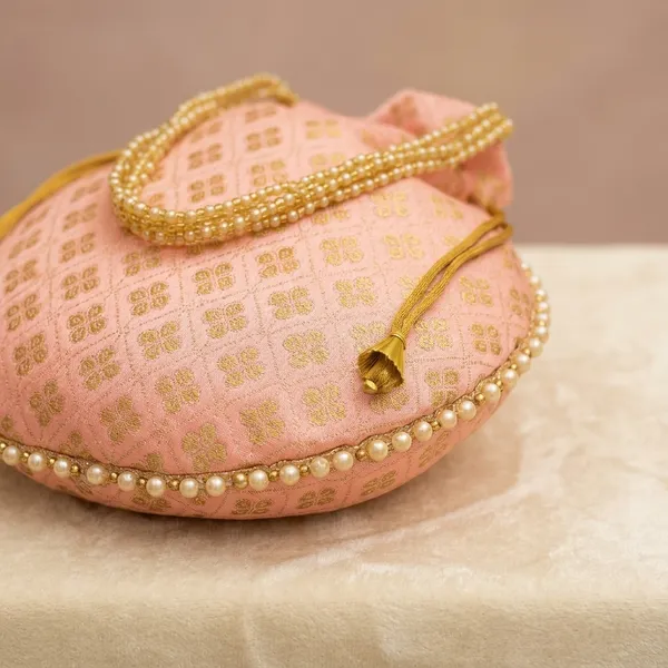 Handcrafted_Silk-Blend_Potli_Bag_with_Golden_Zari_Motifs_&_Pearl_Handle-Light_Pink