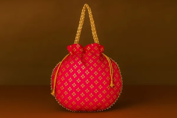 Handcrafted_Silk-Blend_Potli_Bag_with_Golden_Zari_Motifs_&_Pearl_Handle-Pink