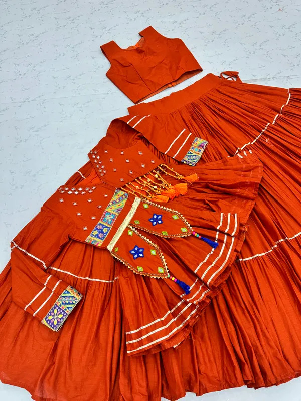 Traditional_Rust-Orange_Cotton_Navratri_Chaniya_Choli_Set_with_Koti_Jacket,_Mirror_Work_&_Gota_Patti_Accent