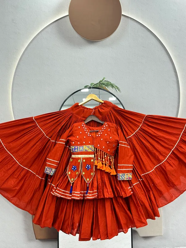 Traditional_Rust-Orange_Cotton_Navratri_Chaniya_Choli_Set_with_Koti_Jacket,_Mirror_Work_&_Gota_Patti_Accent