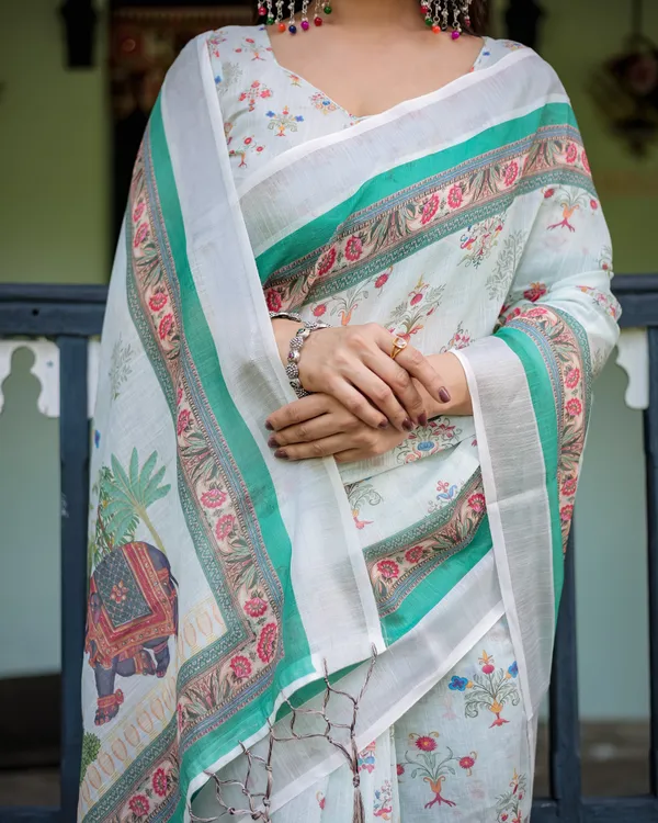 Ivory_Pure_Cotton_Linen_Saree_with_Elephant_Motif_and_Floral_Pattern,_Green_and_Pink_Borders,_and_Tassels_on_Edges.