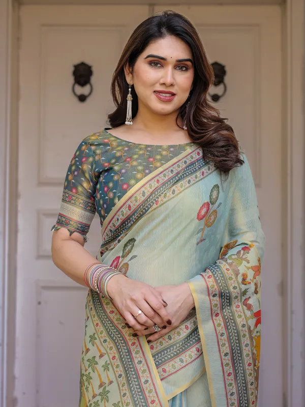 Mint_Green_Folk_Printed_Handloom_Cotton_Saree_with_Village_Scene_Panel_Pallu,_Ornamental_Border_&_Tassels_–_Traditional_Ethnic_Wear
