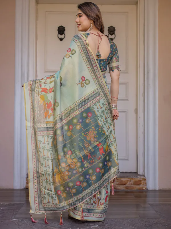 Mint_Green_Folk_Printed_Handloom_Cotton_Saree_with_Village_Scene_Panel_Pallu,_Ornamental_Border_&_Tassels_–_Traditional_Ethnic_Wear