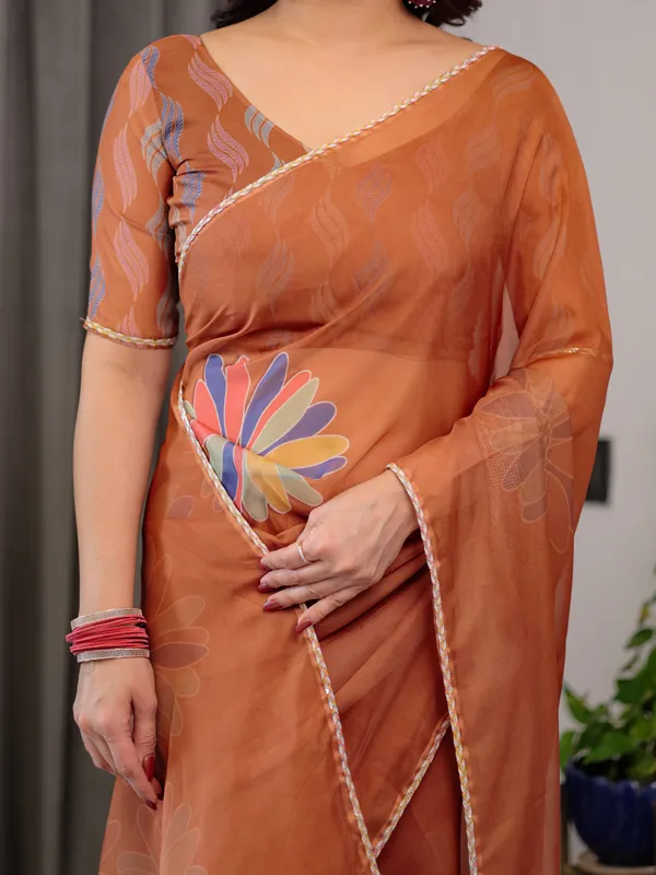 Rust_Orange_Floral_Printed_Organza_Saree_with_Multicolour_Lace_Border_|_Lightweight_Designer_Organza_Saree_with_Attached_Blouse_Piece_|_Elegant_Festive_&_Party_Wear_Saree