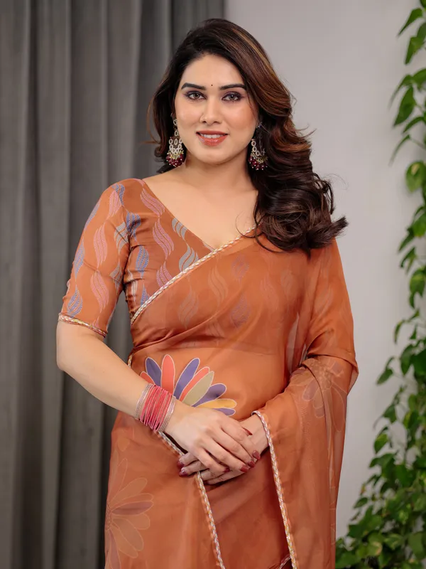 Rust_Orange_Floral_Printed_Organza_Saree_with_Multicolour_Lace_Border_|_Lightweight_Designer_Organza_Saree_with_Attached_Blouse_Piece_|_Elegant_Festive_&_Party_Wear_Saree