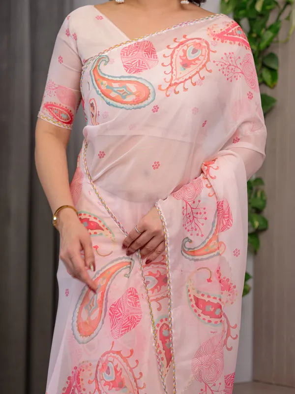 Pastel_Peach_Printed_Organza_Saree_with_Paisley_Motifs_&_Multicolour_Lace_Border_|_Designer_Lightweight_Organza_Saree_with_Attached_Blouse_Piece_|_Elegant_Festive_&_Party_Wear_Saree