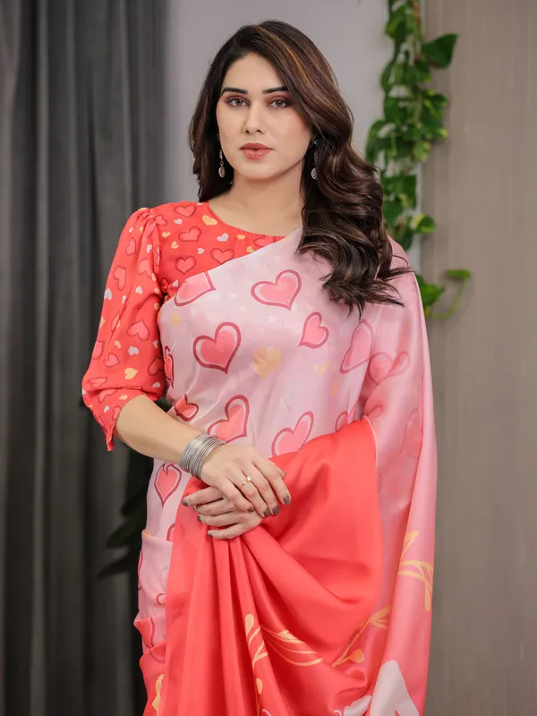 Coral_Red_&_Blush_Pink_Heart_Printed_Satin_Georgette_Saree_with_Romantic_Couple_Pallu_and_Attached_Heart_Print_Blouse_–_5.5_Meter_Designer_Saree_for_Valentine’s_Day_&_Anniversary_Wear
