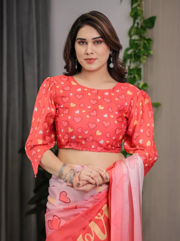 Coral_Red_&_Blush_Pink_Heart_Printed_Satin_Georgette_Saree_with_Romantic_Couple_Pallu_and_Attached_Heart_Print_Blouse_–_5.5_Meter_Designer_Saree_for_Valentine’s_Day_&_Anniversary_Wear